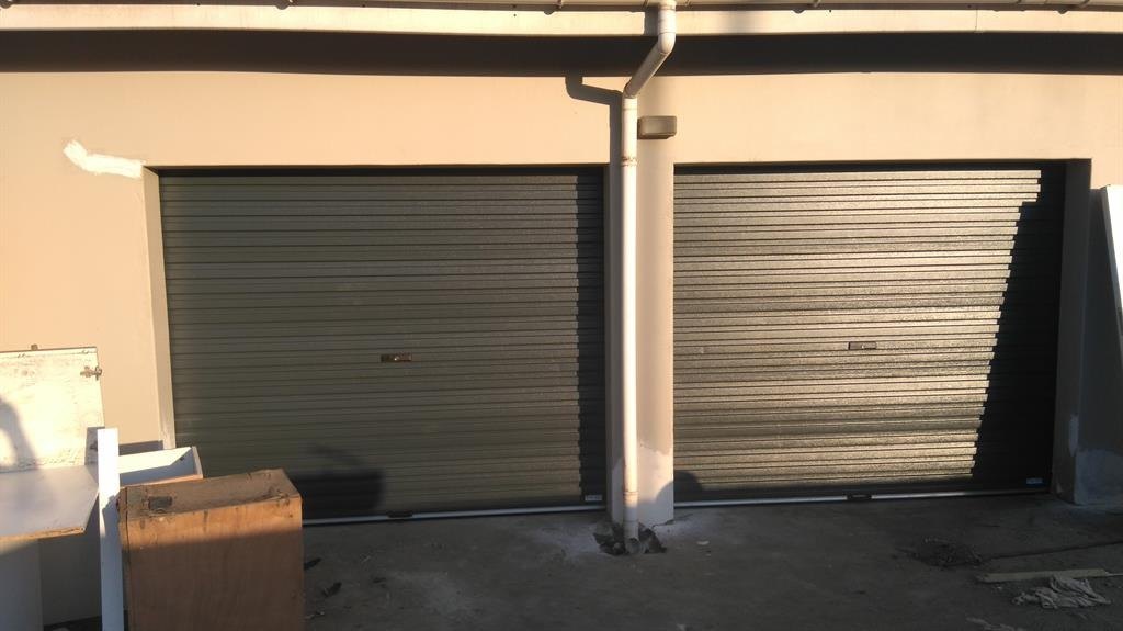 A pair of dark grey roller doors